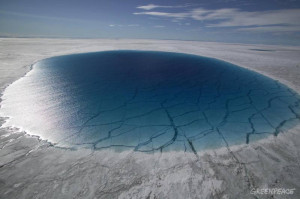 Greenpeace crewmembers help scientists to take depth soundings from the bottom of 'melt-lakes' 4.5 Miles South of Swiss Camp, inland from Disko Bay in West Greenland.