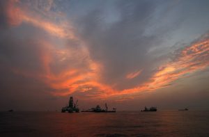 Vessels assist in the drilling of the Deepwater Horizon relief well on the Gulf of Mexico near the coast of Louisiana at sunset. The BP leak, the worst-ever in offshore U.S. waters, occurred at a well that the company was in the process of temporarily closing. The accident killed 11 workers and spilled up to 172 million gallons of oil.